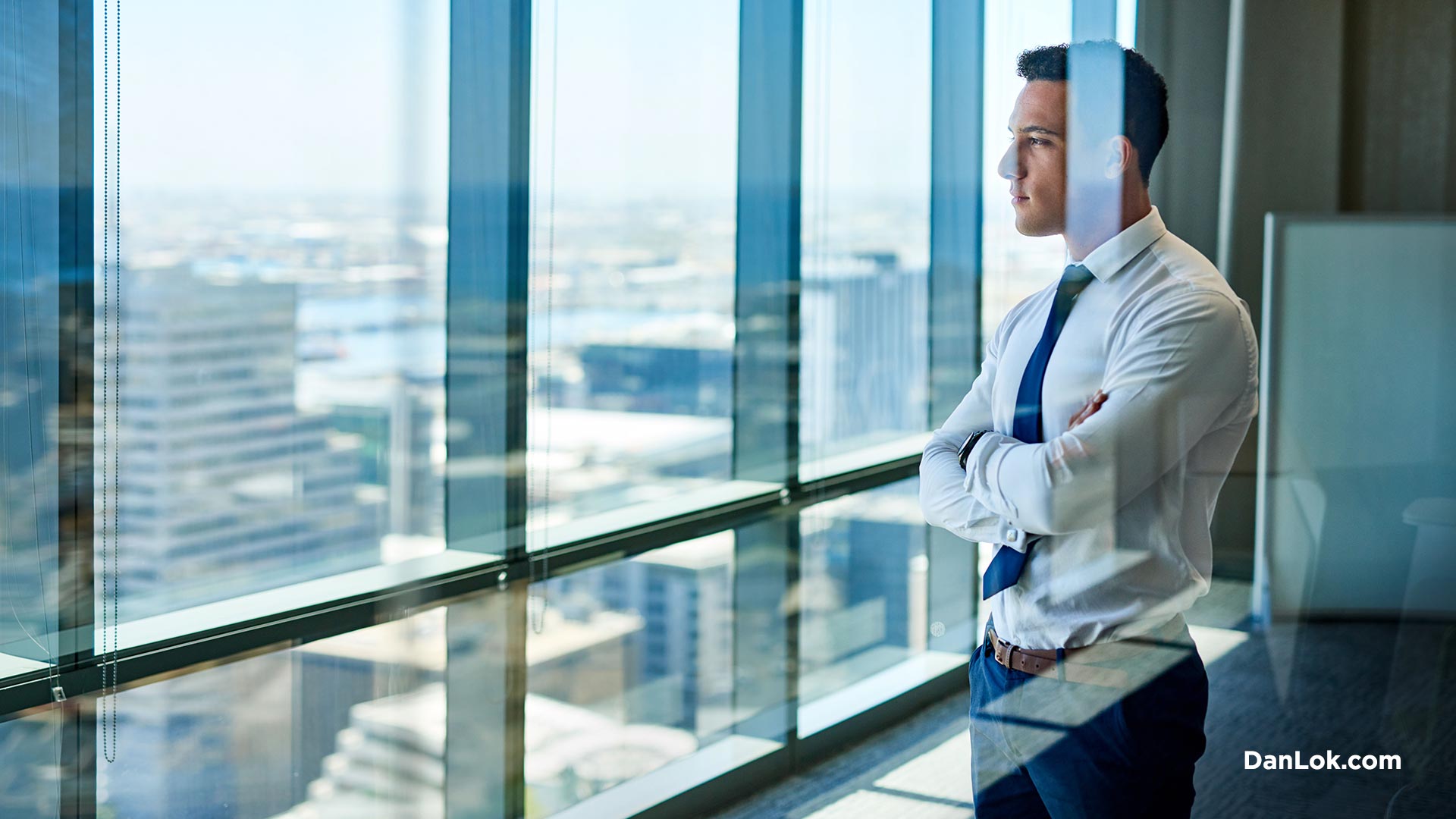 Man evaluating business opportunities staring out the window and thinking
